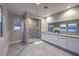 Modern bathroom with a glass-enclosed shower, double sink vanity, and bright natural light at 8984 Rolling Pietra St, Las Vegas, NV 89166