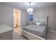 Cozy bedroom with a white wooden bed frame, carpeted floors and ensuite bathroom at 8984 Rolling Pietra St, Las Vegas, NV 89166