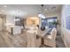 Open floor plan view of the kitchen and dining areas with wood floors and modern lighting at 8984 Rolling Pietra St, Las Vegas, NV 89166