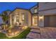 Two-story home showcasing a stucco exterior, a two-car garage, and an inviting entryway with paver walkway at 8984 Rolling Pietra St, Las Vegas, NV 89166