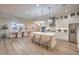Open kitchen and dining area featuring hardwood floors, recessed lighting, modern island and stainless steel appliances at 8984 Rolling Pietra St, Las Vegas, NV 89166