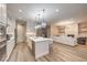 Well-equipped kitchen featuring hardwood floors, recessed lighting, a central island, and stainless steel appliances at 8984 Rolling Pietra St, Las Vegas, NV 89166