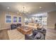 Bright living area featuring hardwood floors, recessed lights, large windows, and stylish furniture at 8984 Rolling Pietra St, Las Vegas, NV 89166