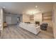 Spacious living room with hardwood floors, recessed lighting, a cozy fireplace, and modern decor at 8984 Rolling Pietra St, Las Vegas, NV 89166