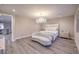 Bright main bedroom features a decorative light fixture and light wood floors at 8984 Rolling Pietra St, Las Vegas, NV 89166