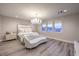 Bright main bedroom with wood floor, couch, and a view of the mountains at 8984 Rolling Pietra St, Las Vegas, NV 89166