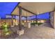 Inviting covered patio with paved flooring and a stone-clad island featuring a built-in gas fire pit at 8984 Rolling Pietra St, Las Vegas, NV 89166