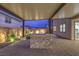 An outdoor patio with a covered structure, paved flooring, and stone-clad island for cooking and dining at 8984 Rolling Pietra St, Las Vegas, NV 89166