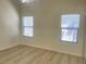 A bright bedroom with two windows and modern floors at 8985 S Durango Dr # 2043, Las Vegas, NV 89113