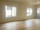 Spacious living room with laminate floors and two bright windows at 8985 S Durango Dr # 2043, Las Vegas, NV 89113