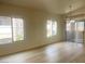 Spacious living room with laminate floors and two bright windows at 8985 S Durango Dr # 2043, Las Vegas, NV 89113