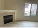 Bright living room with a fireplace, laminate floors, and a large window at 8985 S Durango Dr # 2043, Las Vegas, NV 89113