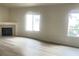 Bright living room with a fireplace, laminate floors, and a large window at 8985 S Durango Dr # 2043, Las Vegas, NV 89113