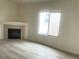 Bright living room with a fireplace, laminate floors, and a large window at 8985 S Durango Dr # 2043, Las Vegas, NV 89113