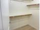 Spacious walk-in closet with wood shelving at 8985 S Durango Dr # 2043, Las Vegas, NV 89113