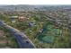 Aerial view of community amenities including clubhouse, pool, and multiple tennis courts at 909 Allister Fields Ln, Las Vegas, NV 89138