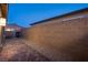 Paver stone backyard featuring a desert landscape and cinder block wall for added privacy at 909 Allister Fields Ln, Las Vegas, NV 89138