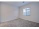 Cozy bedroom with plush carpeting, natural light, and a serene ambiance at 909 Allister Fields Ln, Las Vegas, NV 89138