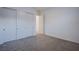 Bedroom featuring neutral carpet, white walls, and a closet with modern sliding doors at 909 Allister Fields Ln, Las Vegas, NV 89138