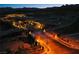 Scenic nighttime entrance to the community with decorative stone and landscape lighting at 909 Allister Fields Ln, Las Vegas, NV 89138