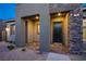 Inviting entryway featuring stone accents, contemporary architecture, and ample lighting for a warm welcome at 909 Allister Fields Ln, Las Vegas, NV 89138