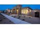 Attractive single-story home featuring neutral color palette, desert landscaping, stone accents, and a sidewalk at 909 Allister Fields Ln, Las Vegas, NV 89138