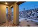 Stylish front porch with stone accents on pillars and a paved pathway leading to a rock wall at 909 Allister Fields Ln, Las Vegas, NV 89138