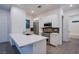 Bright kitchen features white cabinets, stainless steel appliances, a spacious island, and tile flooring at 909 Allister Fields Ln, Las Vegas, NV 89138