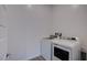 Modern laundry room equipped with a front-load washing machine and a dryer set at 909 Allister Fields Ln, Las Vegas, NV 89138