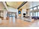 Spacious lounge area with high ceilings, stone fireplace, comfortable seating, and expansive windows at 909 Allister Fields Ln, Las Vegas, NV 89138
