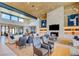 Elegant lounge with cozy armchairs, stylish lighting, and a stone fireplace, perfect for relaxing at 909 Allister Fields Ln, Las Vegas, NV 89138