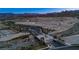 Aerial view of the community entrance featuring stone accents, desert landscape, and mountain views at 909 Allister Fields Ln, Las Vegas, NV 89138