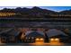 Aerial nighttime view of new homes in a desert community with mountain views and landscape lighting at 909 Allister Fields Ln, Las Vegas, NV 89138