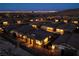 Aerial nighttime view of houses in a community with mountain and Vegas skyline views at 909 Allister Fields Ln, Las Vegas, NV 89138