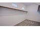 Walk-in closet featuring ample storage space, wood-look floors, and natural light at 909 Allister Fields Ln, Las Vegas, NV 89138