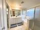 Bright bathroom featuring double vanity, bathtub and shower, and decorative artwork at 9205 Valley Betica Ave, Las Vegas, NV 89148