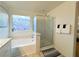 Bright bathroom featuring bathtub and shower, as well as decorative artwork at 9205 Valley Betica Ave, Las Vegas, NV 89148