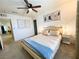 Inviting bedroom featuring a cozy bed, ceiling fan, and neutral color palette at 9205 Valley Betica Ave, Las Vegas, NV 89148