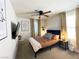 Well-lit bedroom featuring ceiling fan, contemporary decor, and streaming sunlight at 9205 Valley Betica Ave, Las Vegas, NV 89148