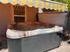 Private hot tub featuring multi-tone skirt and retractable shade awning at 9205 Valley Betica Ave, Las Vegas, NV 89148