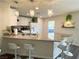 Modern kitchen with granite counters, breakfast bar, stainless steel sink, and pendant lighting at 9205 Valley Betica Ave, Las Vegas, NV 89148