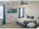 Cozy main bedroom with white bedding, teal drapes, ceiling fan, and decorative art at 9205 Valley Betica Ave, Las Vegas, NV 89148