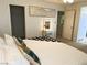 Main bedroom with white bedding, decorative pillows, dressing table and adjoining closet at 9205 Valley Betica Ave, Las Vegas, NV 89148