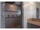 Walk-in shower featuring glass door, dual shower heads, and tiled surround in remodeled bathroom at 9325 Canyon Classic Dr, Las Vegas, NV 89144