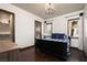 Cozy bedroom features dark wood floors, large window and walk-in closet at 9325 Canyon Classic Dr, Las Vegas, NV 89144