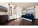 Well-lit bedroom with hardwood floors, modern furniture, and large windows overlooking a sunny view at 9325 Canyon Classic Dr, Las Vegas, NV 89144