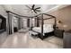 Spacious bedroom featuring a four-poster bed, a chaise lounge, and large windows with natural light at 9325 Canyon Classic Dr, Las Vegas, NV 89144