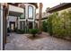 Beautiful courtyard with brick pavers, lush greenery, and large windows offering ample natural light at 9325 Canyon Classic Dr, Las Vegas, NV 89144