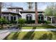 Stunning two-story home featuring lush landscaping, a stone pathway, and a well-manicured lawn at 9325 Canyon Classic Dr, Las Vegas, NV 89144