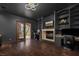 Large game room with fireplace, built in shelves, desks and a view of the outdoors at 9325 Canyon Classic Dr, Las Vegas, NV 89144